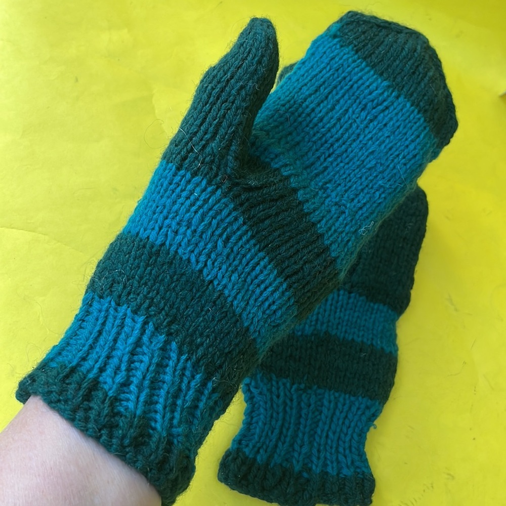 Green hand knitted wool mittens